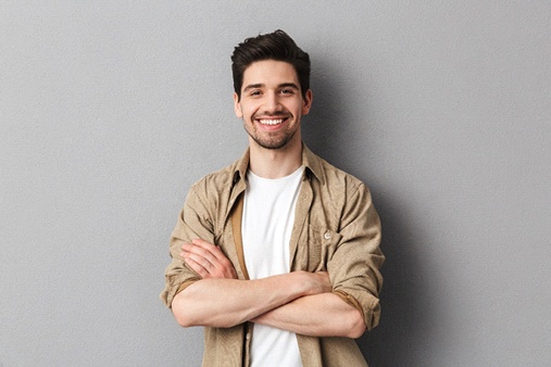 person smiling and crossing their arms