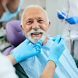 Man with white hair about to have dental exam