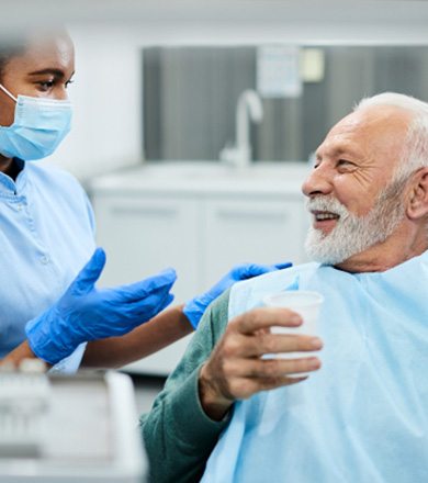 dentist talking to patient about dental implants in Norwalk