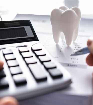 Patient in Norwalk budgeting for dental implants