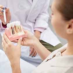 Dental implants patient in Norwalk talking to dentist