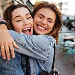 Dental implants Patient in Norwalk smiling with friend