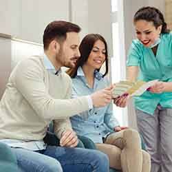 Dental implants Patient in Norwalk talking to dental team