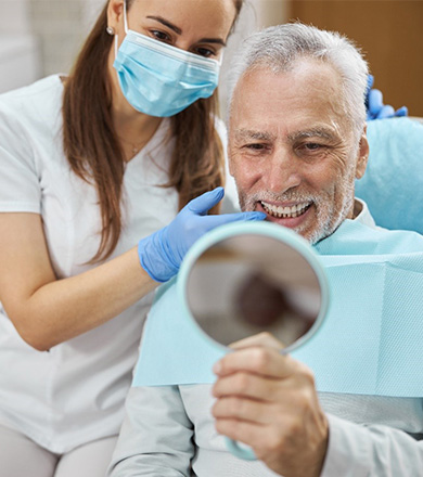 dentist talking to patient about dental implants in Norwalk