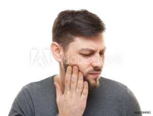 man holding face toothache