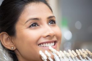 Smiling woman getting porcelain veneers in Norwalk