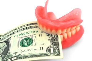 Dollar bill between upper and lower dentures 