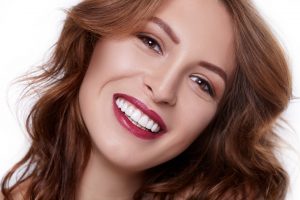 Smiling woman wearing red lipstick