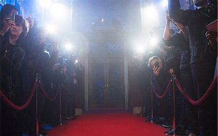 paparazzi taking photos around red carpet